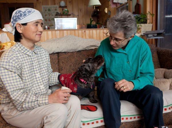 Frances Herbert, right, and her wife, Takako Ueda, pose for photos with their dog, Little Bear, at their home in Dummerston, Vt., Wednesday, Dec. 21, 2011.