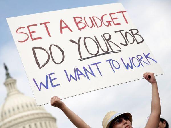 A furloughed federal worker protests outside the U.S. Capitol last week, demanding an end to the shutdown.