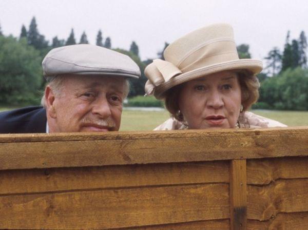 Richard and Hyacinth Bucket peer over a fence.
