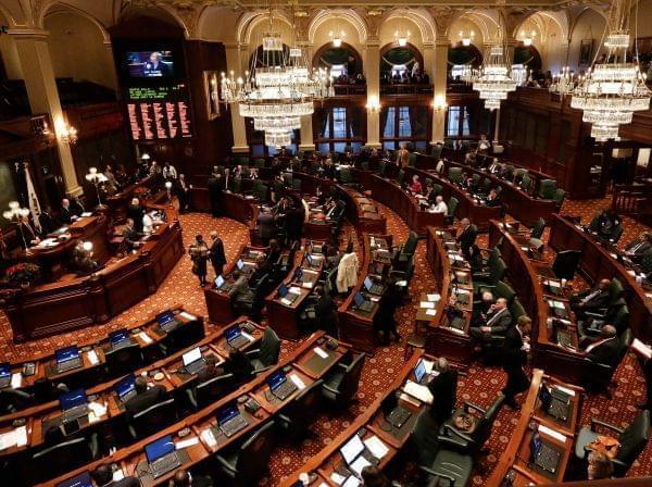 Lawmakers work toward passing pension legislation while on the House floor during session at the Illinois State Capitol Tuesday, Dec. 3, 2013 in Springfield Ill.
