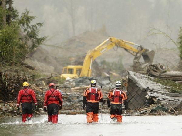 Searchers approach the site of the mudslide in Oso, Washington.