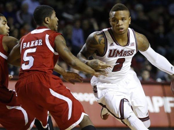 Massachusetts' Derrick Gordon (No. 2) drives past Northern Illinois' Dontel Highsmith (No. 4) and Travon Baker (No. 5) during an NCAA basketball game in Amherst, Mass., on Dec. 14.