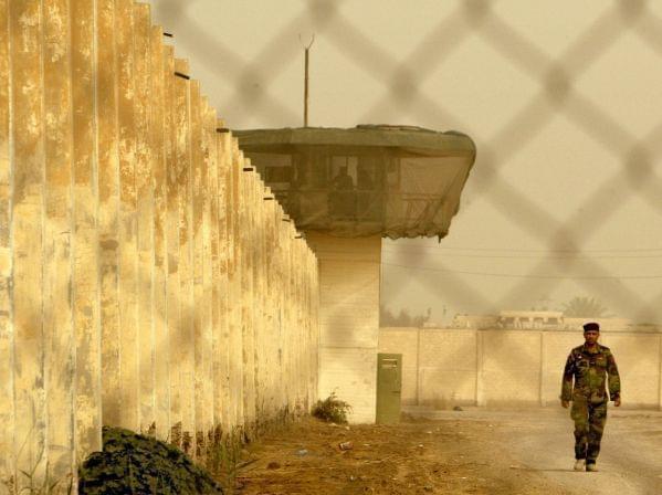 An Iraqi security officer patrols the grounds at Baghdad Central Prison in Abu Ghraib, in 2009.